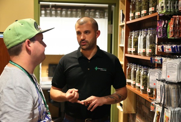Denver Relief marijuana store co-owner Kayvan Khalatbari, right, talks with his employee Jeff Botkin. Khalatbari also runs Denver Relief Consulting, which assists current and would-be marijuana-related businesses around the country. (AP Photo)