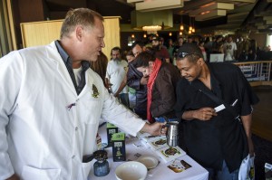 Extracting Innovations COO Seth Cox shows Navy veteran Hikima Nukes how to make active butter for edibles at the Grow 4 Vets cannabis giveaway at the DoubleTree Hotel Saturday, Sept. 27, 2014 in Colorado Springs, Colo. Veterans who RSVPed for the event were given gift bags with cannabis seeds, infused candy bars and a cannabis tincture. (AP Photo/The Gazette, Michael Ciaglo)