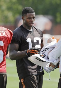 In this Aug. 20, 2014 photo, Cleveland Browns wide receiver Josh Gordon (12) takes a break during practice at the NFL football team's facility in Berea, Ohio. On Aug. 27, the NFL suspended Gordon for one year after he tested positive for marijuana under the league's old rules. (AP Photo/Mark Duncan)