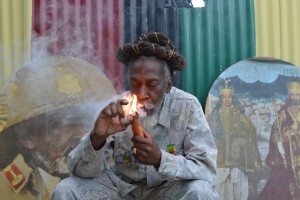 Legalization advocate and reggae legend Bunny Wailer smokes a pipe stuffed with marijuana in Kingston, Jamaica.  (David McFadden/Associated Press)