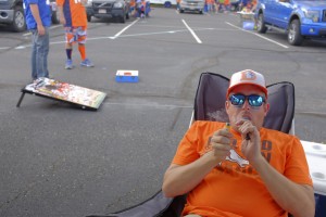 A Denver Broncos fan smokes marijuana in the parking lot while tailgating at Sports Authority Field at Mile High in Denver, Sept. 7, 2014. While marijuana is now legal in Colorado, the Broncos have followed the NFL in taking a position of disapproval. That has not deterred fans from toking up before games. (Matthew Staver/The New York Times)