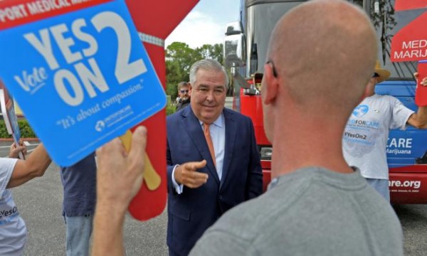 John Morgan speaks with Paul Tuttle of Sarasota who says he "supports the right to natural alternatives" before Morgan's talk in a forum on medical marijuana Thursday in Sarasota. (STAFF PHOTO / THOMAS BENDER)
