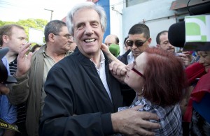 Presidential candidate for the ruling Broad Front party Tabare Vazquez, left, embraces a follower after casting his vote during general elections in Montevideo, Uruguay, Sunday, Oct. 26, 2014. Uruguay’s presidential election is set to go into a runoff as undecided voters could opt for change on Sunday, despite an economic boom and social reforms led by the ruling Broad Front coalition. (AP Photo/Natacha Pisarenko) 