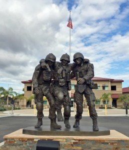 This photo provided by Hope For The Warriors shows a sculpture dedicated to wounded soldiers after its unveiling at Marine Base Camp Pendleton, Calif., Wednesday, Nov. 12, 2014. The sculpture is based on a photograph of two lance corporals carrying an injured sergeant out of a house a decade ago in Fallujah, Iraq. The artwork was sponsored by Hope For The Warriors, a national nonprofit that assists wounded members of the military and their families. (AP Photo/Hope For The Warriors, Erin Thompson)