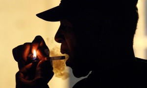 An unidentified man smoking medical marijuana during karaoke night at the Cannabis Cafe, in Portland, Ore.  (AP Photo/Rick Bowmer, File) 