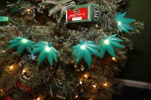 In this photograph taken on Thursday, Nov. 20, 2014, plastic marijuna leaves light a Christmas tree as part of holiday display in a recreational marijuana shop in northwest Denver. (AP Photo/David Zalubowski)