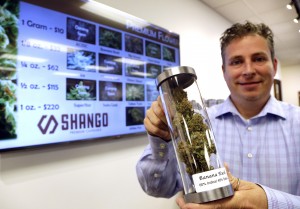 Shane Mckee, co-founder of Shango Premium Cannabis dispensary, shows a sample of medical marijuana in Portland, Ore., Wednesday, Nov. 5, 2014. Oregon voters have made their state the third to legalize recreational pot, but it will be more than a year before the first shops open. But dispensaries that already sell medical marijuana are expected to start taking steps to get their applications in to sell recreational weed as well. (AP Photo/Don Ryan)