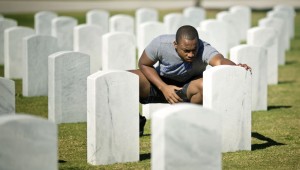 Jeff Thelusme visits a friend's grave at the South Florida National Cemetery in Lake Worth, Florida. They served in Afghanistan together. His friend, suffering from PTSD, died in a drowning after coming home. (AP File Photo/J Pat Carter) 
