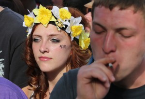 Partygoers listen to live music and smoke pot on the second of two days at the annual 4/20 marijuana festival in Denver, Sunday April 20, 2014. The annual event is the first 420 marijuana celebration since retail marijuana stores began selling in January 2014. (AP Photo/Brennan Linsley)