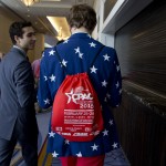 Matthew Foldi of Maryland, wearing a star emblazoned blazer and carrying a Conservative Political Action Conference (CPAC), attends the CPAC conference in National Harbor, Md., Friday, Feb. 27, 2015. (AP Photo/Carolyn Kaster)