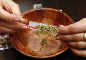 Rolling a marijuana joint is demonstrated by Rica Madrid in her home on the first day of legal possession of marijuana for recreational purposes, Thursday, Feb. 26, 2015, in Washington. Democratic Mayor Muriel Bowser defied threats from Congress by implementing a voter-approved initiative on Thursday, making the city the only place east of the Mississippi River where people can legally grow and share marijuana in private. (AP Photo/Alex Brandon)