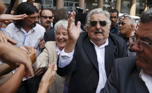 Uruguay's former President Jose Mujica and wife Lucia Topolansky greet supporters after the swearing-in ceremony for Uruguay's new President Tabare Vazquez at Independence Plaza in Montevideo, Uruguay, Sunday, March 1, 2015. Mujica, who still lives on a flower farm with his wife, rarely dons a tie and drives an old VW Beetle, has led Uruguay through stable economic growth and better wages. His social agenda has included laws approving gay marriage and the creation of the world's first national marketplace for legal marijuana. (AP Photo/Matilde Campodonico)   