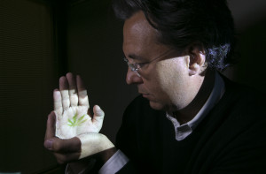 Dr. Mark Ware, the director of the Canadian Consortium for the Investigation of Cannabinoids, with a marijuana leaf image projected on his hand, in Montreal, March 18, 2015. Scientific research into the appropriate uses of medical marijuana has lagged. Ware would like to change that. (Christinne Muschi/The New York Times)