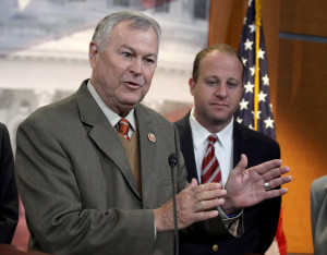 Rep. Dana Rohrabacher, R-Calif., left, accompanied by Rep. Jared Polis, D-Colo., speaks during a news conference on Capitol Hill in Washington, Thursday, Nov, 13, 2014, to discuss marijuana laws. The legislators came together again Wednesday to discuss the issue in the wake of the riots in Baltimore. (AP Photo/Lauren Victoria Burke) 