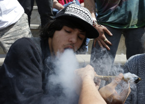 Partygoers listen to music and smoke marijuana on one of several days of the annual 4/20 marijuana festival, in Denver's downtown Civic Center Park, Saturday April 18, 2015. The annual event is the second 4/20 marijuana celebration since retail marijuana stores began selling in January 2014. (AP Photo/Brennan Linsley)