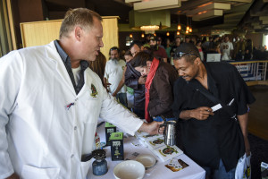 Extracting Innovations COO Seth Cox shows Navy veteran Hikima Nukes how to make active butter for edibles at the Grow 4 Vets cannabis giveaway at the DoubleTree Hotel Saturday, Sept. 27, 2014 in Colorado Springs, Colo. (AP Photo/The Gazette, Michael Ciaglo)   