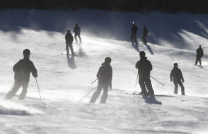 Skiers and snowboarders take a run at Breckenridge, in Colo. Business is booming in Colorado’s mountain resorts, and the addition of recreational marijuana stores this year has attracted droves of customers curious about legalized pot.   (AP Photo/Brennan Linsley)   
