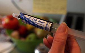 An oral administration syringe loaded with with high CBD hemp oil for treating a severely-ill child is shown at a private home in Colorado Springs, Colo.  (AP Photo/Brennan Linsley)