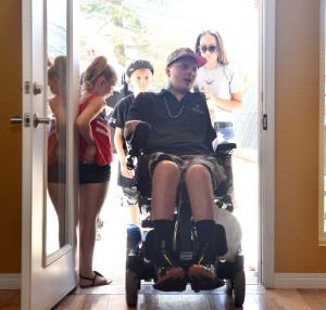 Wounded Iraq War veteran Jerral Hancock and his family walk into their new specially adapted custom "Smart Home" Friday, May 29, 2015, in Palmdale, Calif.  (Ruby Varela/The Antelope Valley Press via AP)