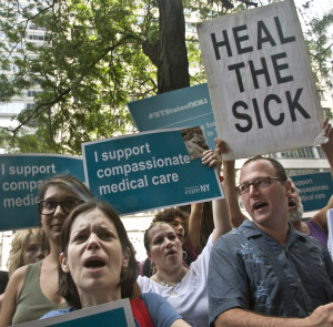 A coalition of patients and caregivers gather outside Gov. Andrew Cuomo's office in July 2015 to plead for early access to medical marijuana treatment for seizure sufferers in New York. Health officials have picked five companies to grow and dispense marijuana under the state's new medical marijuana law. The five include a family business founded by a woman whose mother died of ALS, a company run by a Minnesota physician and others with experience running dispensaries in other states. NY's program is expected to begin in 2016. (AP Photo/Bebeto Matthews, File)