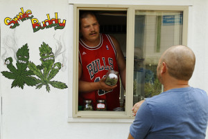 Matt Stein talks with Larry, who declined to give a surname, in the Smoke Buddy mobile medical marijuana cart, parked in the St Johns neighborhood of Portland, Ore. The photo was shot on Aug. 22. Oregon Health Authority said  Aug. 24, that  the Smoke Buddy is illegal .  (Mike Zacchino/The Oregonian via AP) 