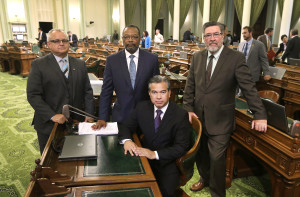 California Assemblymen, from left, Tom Lackey, R-Palmdale, Reginald Jones-Sawyer, D-Los Angeles, Rob Bonta, D-Oakland, and Ken Cooley, D-Rancho Cordova, pose for a photo at the Capitol in Sacramento, Calif. California lawmakers were expected to vote Friday, Sept. 11, on a proposal to create the first regulatory framework for the state's thriving but unruly medical marijuana industry after lawmakers reached an 11th-hour compromise on a trio of marijuana bills. (AP Photo/Rich Pedroncelli, File)