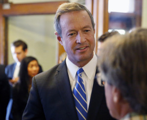 Democratic presidential candidate, former Maryland Gov. Martin O'Malley, left, talks with an attendee at a round table meeting in Denver, Thursday, Sept. 17, 2015. O'Malley met with Colorado officials and marijuana activists and business owners in Denver Thursday, where he repeated his pledge to reclassify marijuana under federal drug laws if elected. (AP Photo/Brennan Linsley)