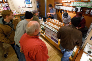Employees of Amazon Organics, a pot dispensary in Eugene, Ore., help customers purchase recreational marijuana on Thursday, Oct. 1, 2015. Oregon marijuana shops began selling marijuana Thursday for the first time to recreational users who are at least 21 years old, marking a big day for the budding pot industry. (AP Photo/Ryan Kang)